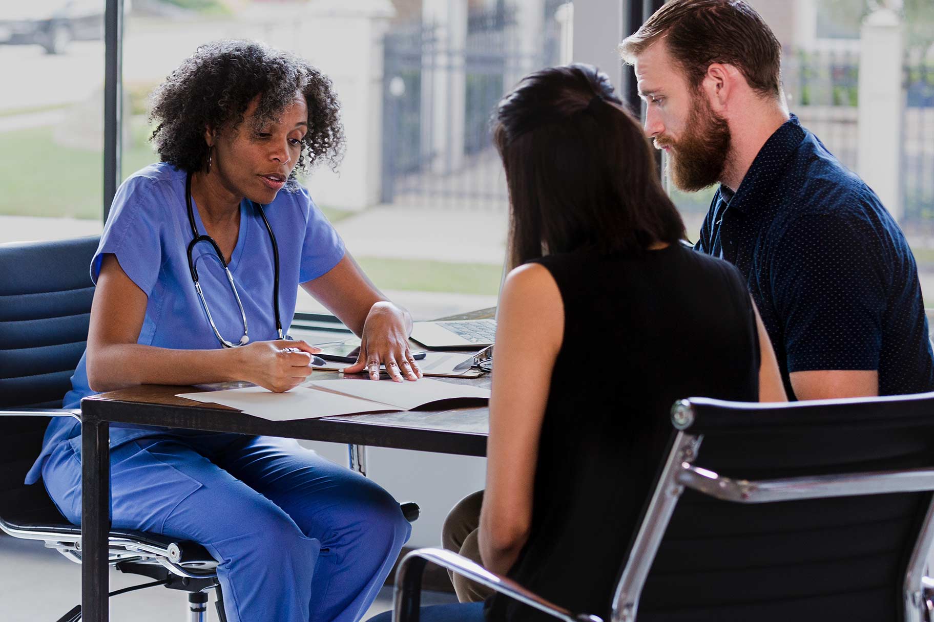 Doctor consults a pregnant woman and husband