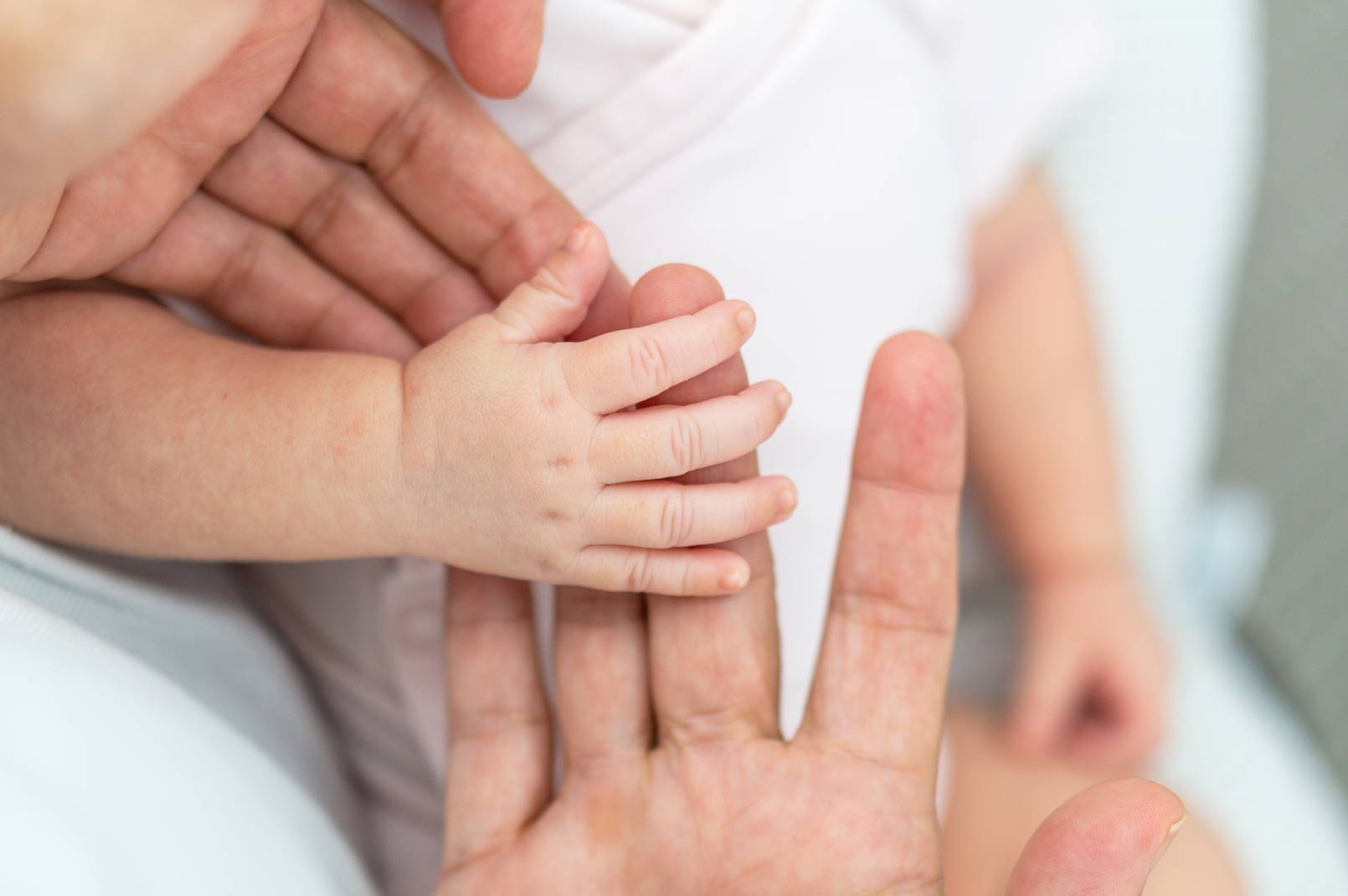 parents and baby hands