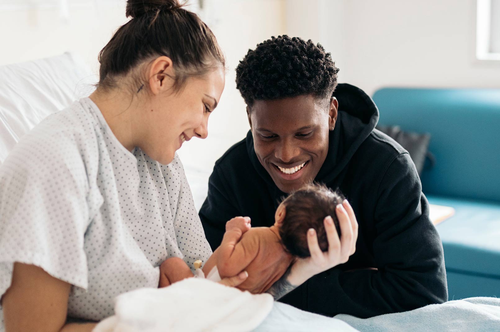 Mother and father holding newborn
